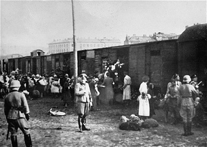 Jews loading onto trains at the Umschlagplatz in Warsaw during the German occupation of Poland. Umschlagplatz is German for collection or reloading point. This photo is of the square in Warsaw where, under German occupation, Jews gathered for deportation from the Warsaw Ghetto to Treblinka.