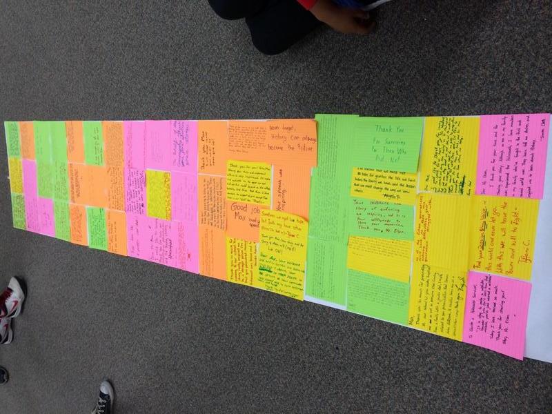 Students collect individual reflections following a survivor testimony to form a banner 