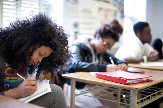 Students write in their journals / thoughtbooks in response to learning on difficult histories of genocide. Image courtesty Nick Kozak for Facing History and Ourselves.